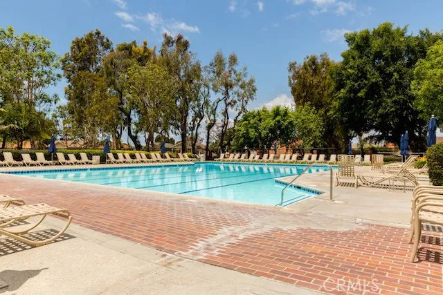 a view of a swimming pool with an outdoor space and seating area