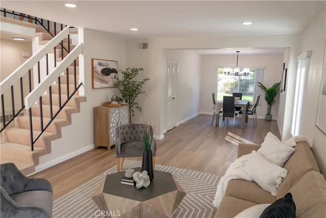 a living room with furniture flowerpot and a chandelier