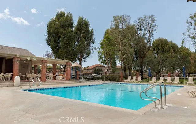 a view of a swimming pool with outdoor seating
