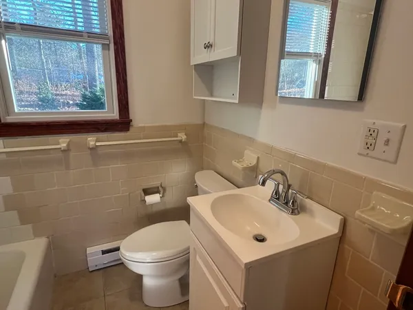 a white toilet sitting next to a bathroom sink