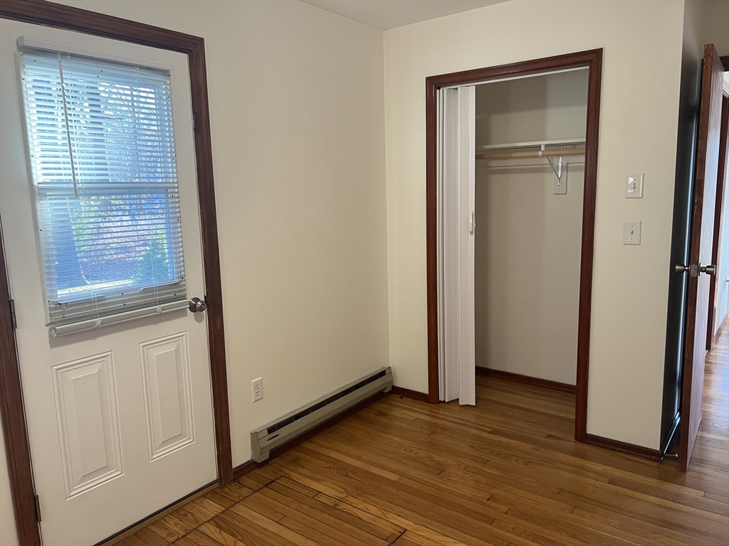 5 2nd Road, Unit 5 Hopkinton, MA 01748 - Photo 16 of 19 a view of empty room with wooden floor and window