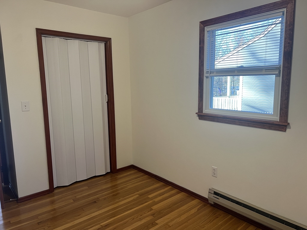 5 2nd Road, Unit 5 Hopkinton, MA 01748 - Photo 18 of 19 a view of empty room with wooden floor and fan