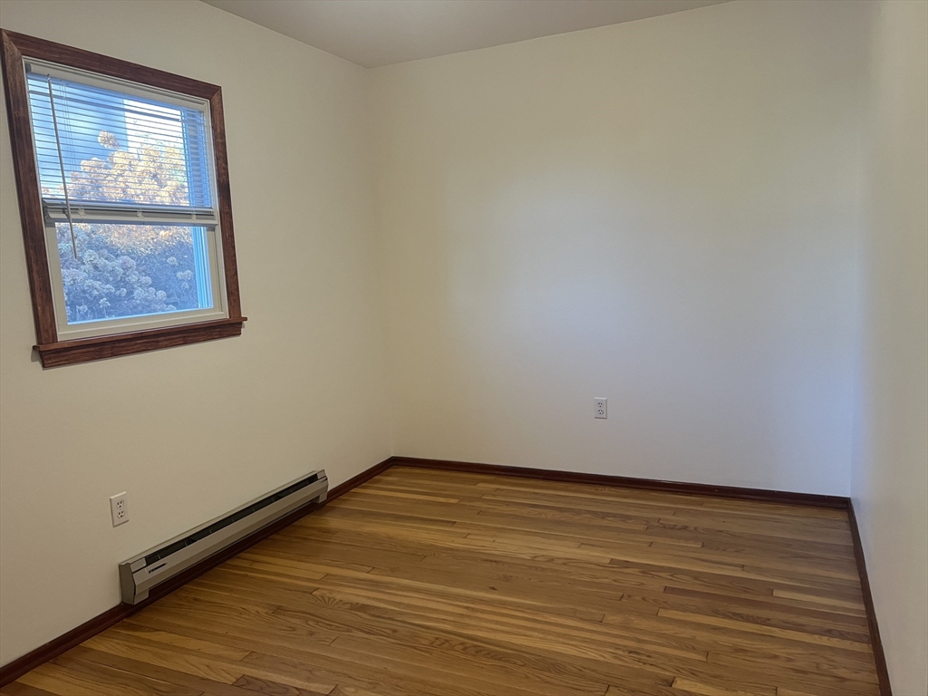 5 2nd Road, Unit 5 Hopkinton, MA 01748 - Photo 19 of 19 a view of an empty room with wooden floor and a window