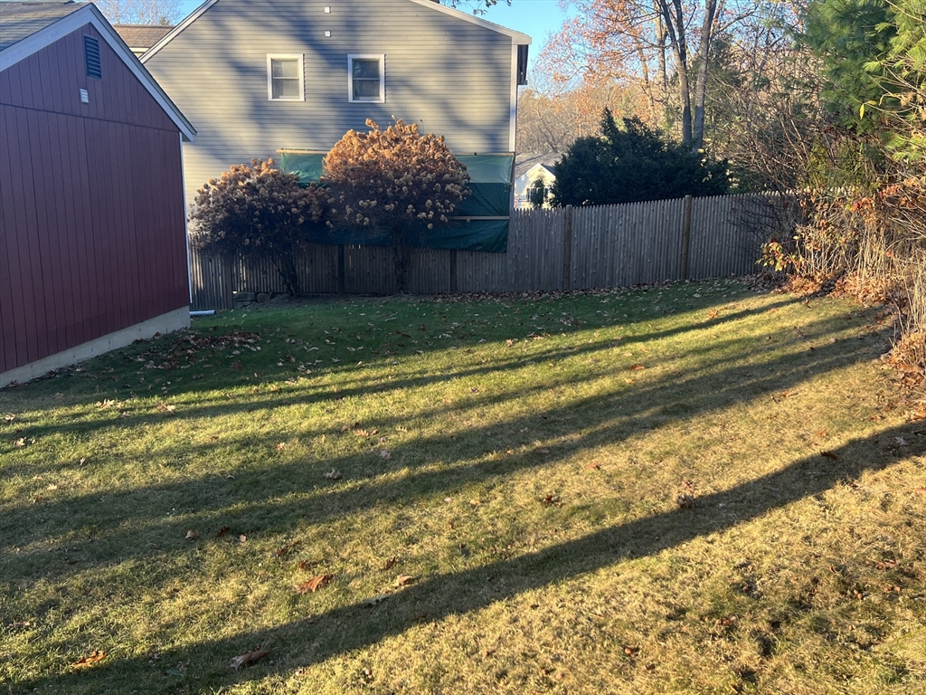 5 2nd Road, Unit 5 Hopkinton, MA 01748 - Photo 4 of 19 a view of backyard with wooden fence