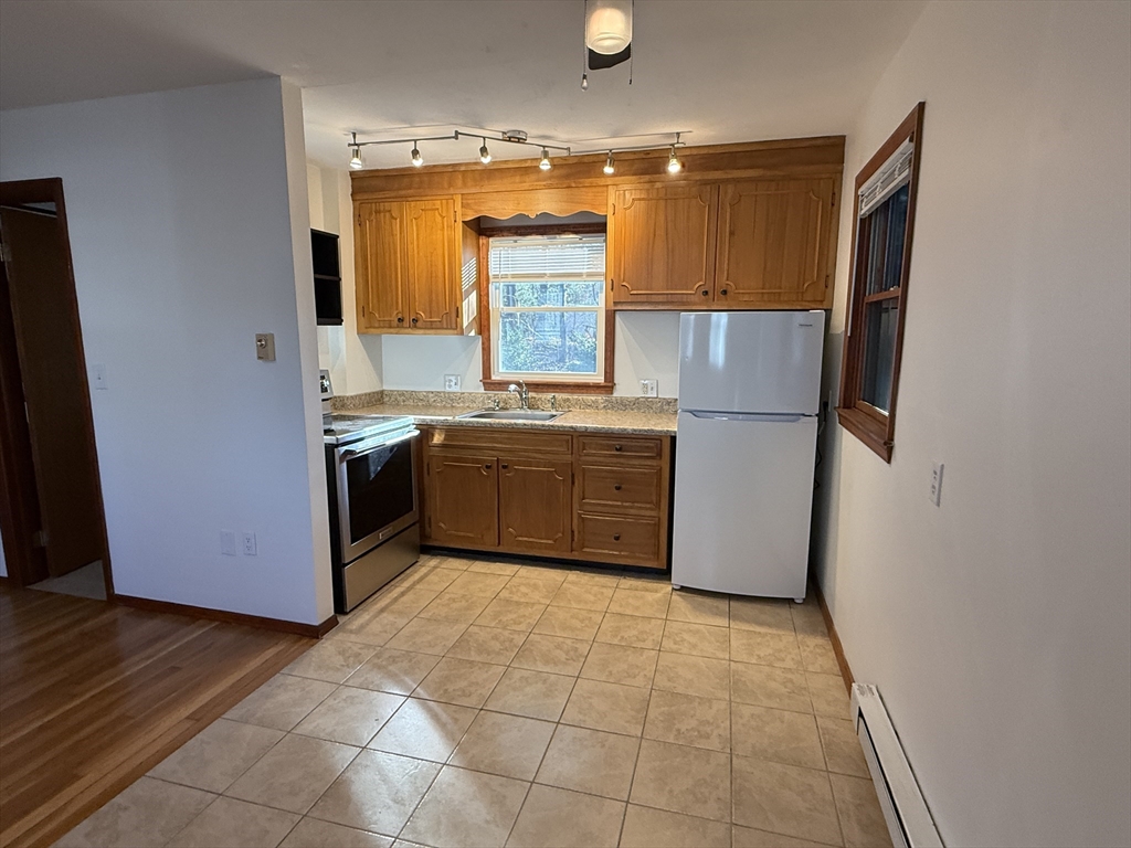 5 2nd Road, Unit 5 Hopkinton, MA 01748 - Photo 10 of 19 a kitchen with stainless steel appliances granite countertop a stove a sink and a refrigerator