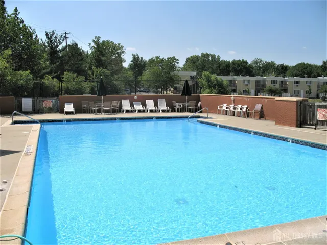 a view of a swimming pool and lounge chairs