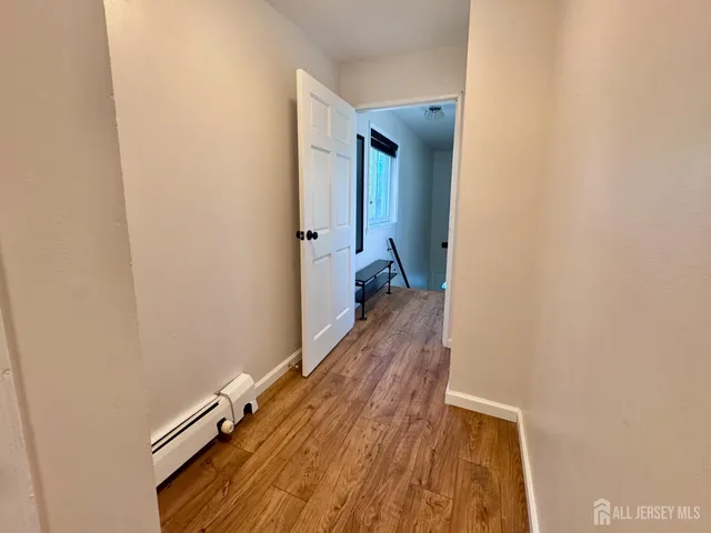 a view of a room with wooden floor