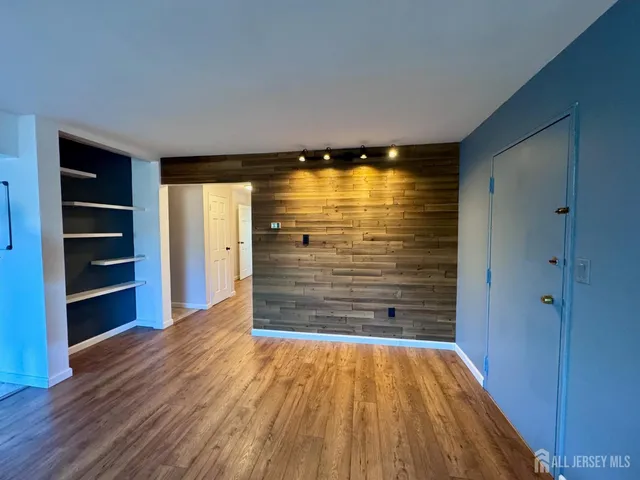 a view of walk in closet with wooden floor