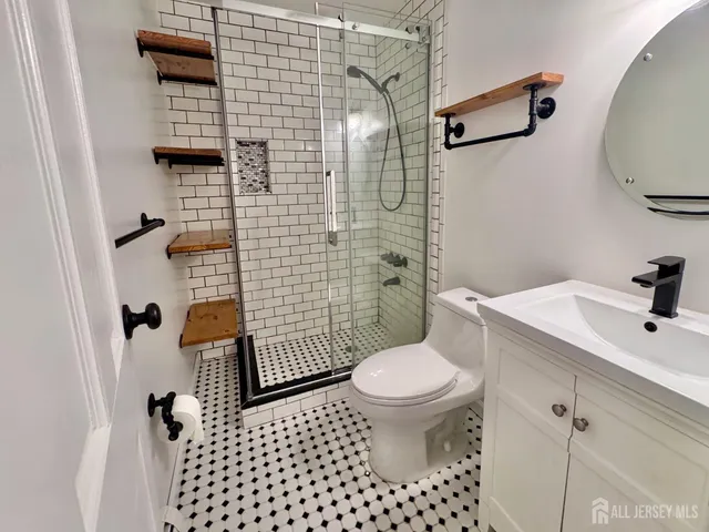 a bathroom with a sink toilet and shower