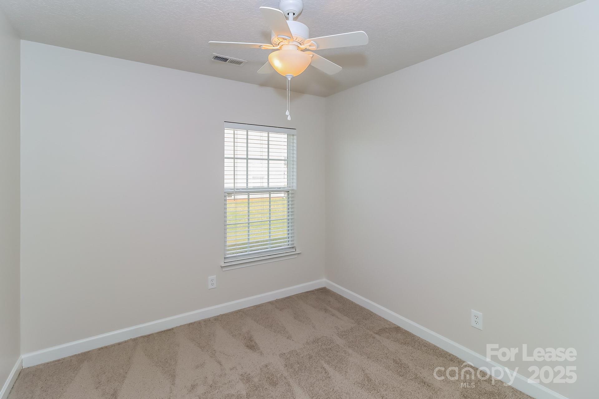 3624 Crowders View Drive Gastonia, NC 28052 - Photo 11 of 16 an empty room with a window and a fan