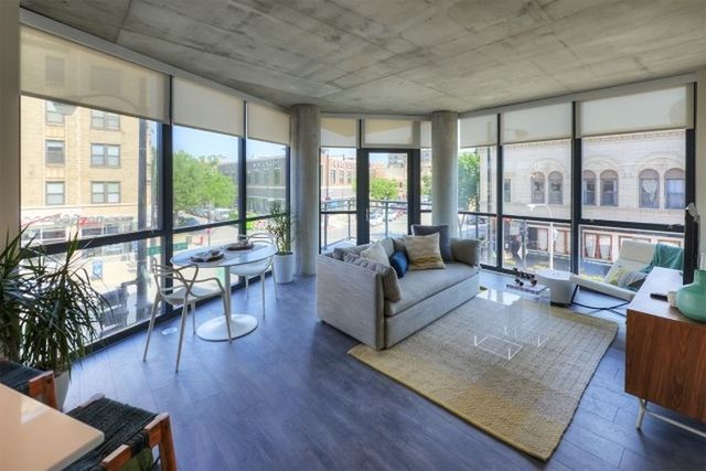 Undisclosed Address Chicago, IL 60657 - Photo 7 of 12 a living room with furniture and a large window with wooden floor