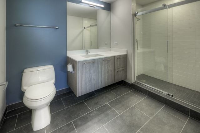 Undisclosed Address Chicago, IL 60657 - Photo 9 of 12 a bathroom with a toilet sink and a mirror