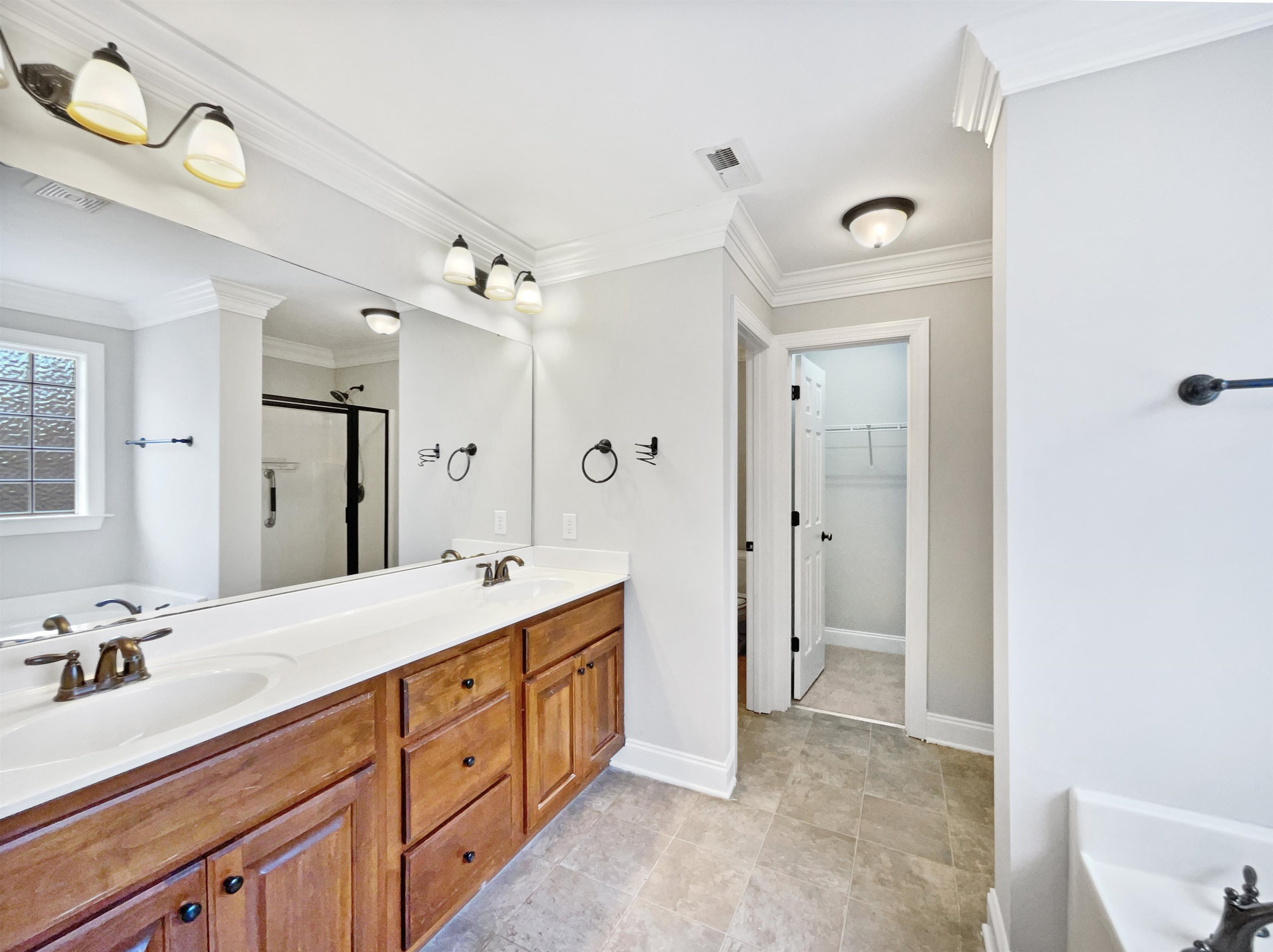 90 Bertram Drive Clayton, NC 27520 - Photo 16 of 19 a spacious bathroom with a double vanity sink mirror and double