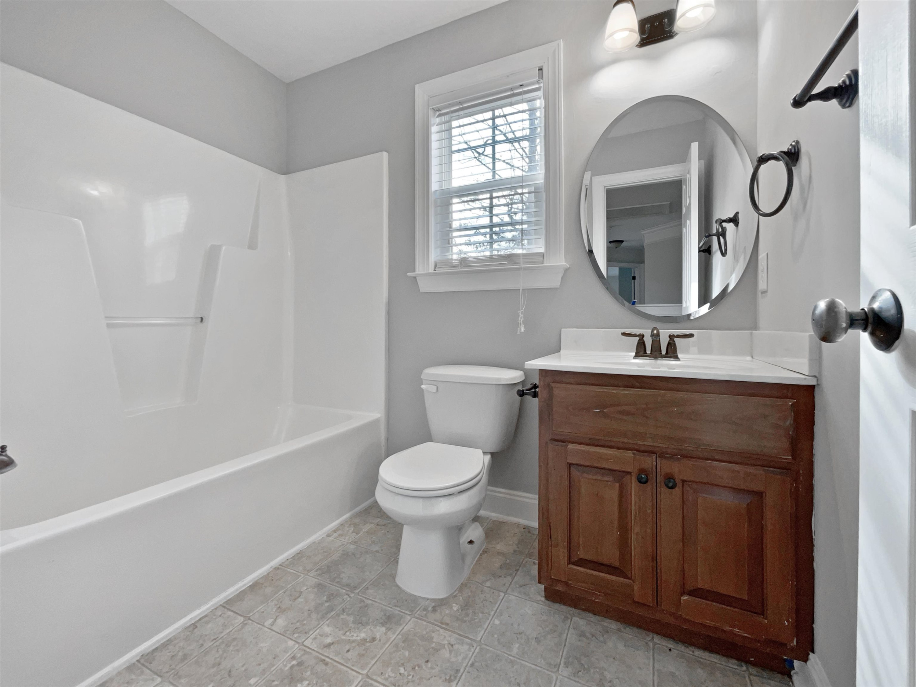90 Bertram Drive Clayton, NC 27520 - Photo 18 of 19 a bathroom with a toilet sink and mirror