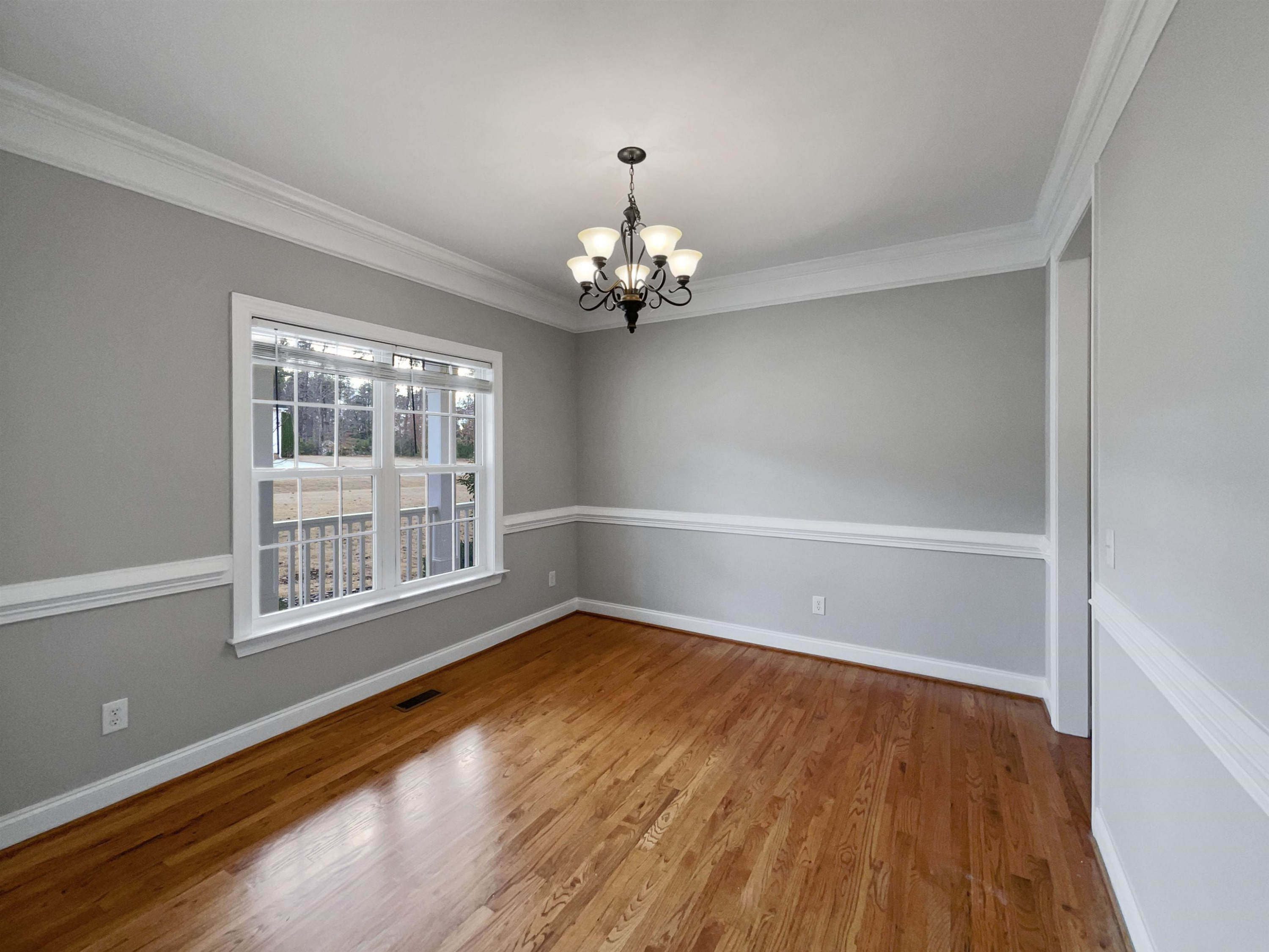 90 Bertram Drive Clayton, NC 27520 - Photo 3 of 19 a view of an empty room with wooden floor and a window