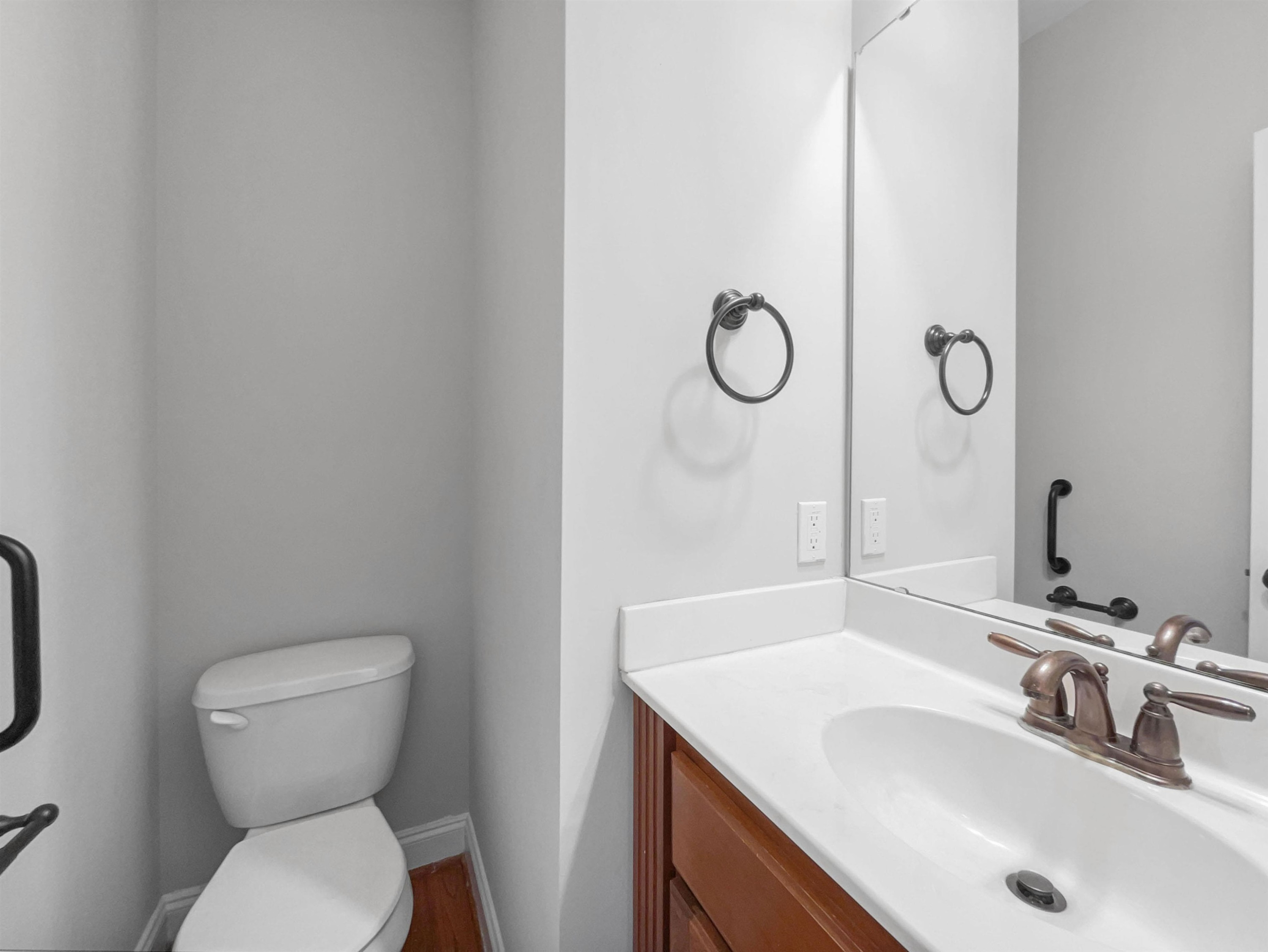 90 Bertram Drive Clayton, NC 27520 - Photo 4 of 19 a bathroom with a toilet sink vanity and mirror