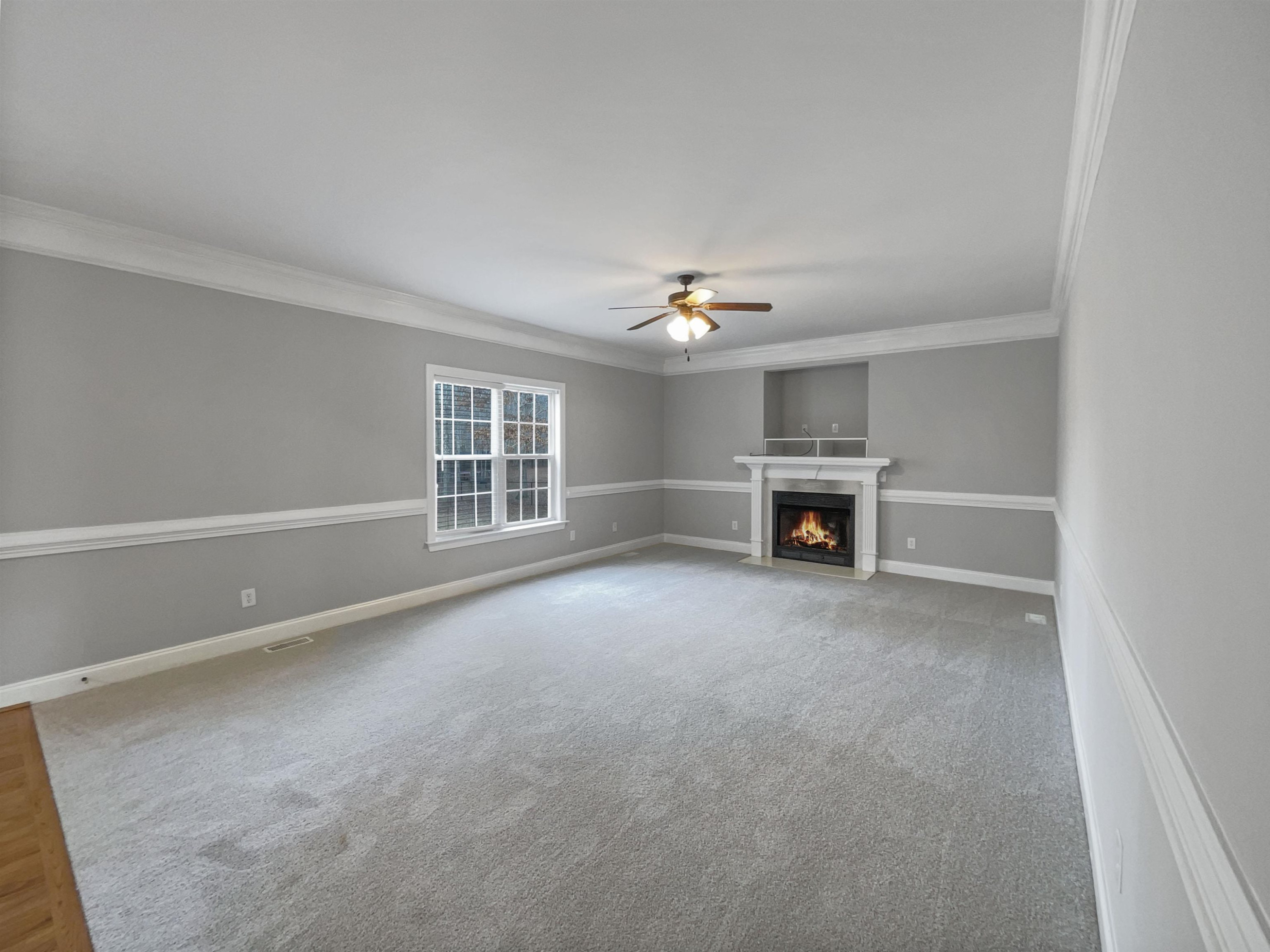 90 Bertram Drive Clayton, NC 27520 - Photo 5 of 19 a view of an empty room with a fireplace and chandelier
