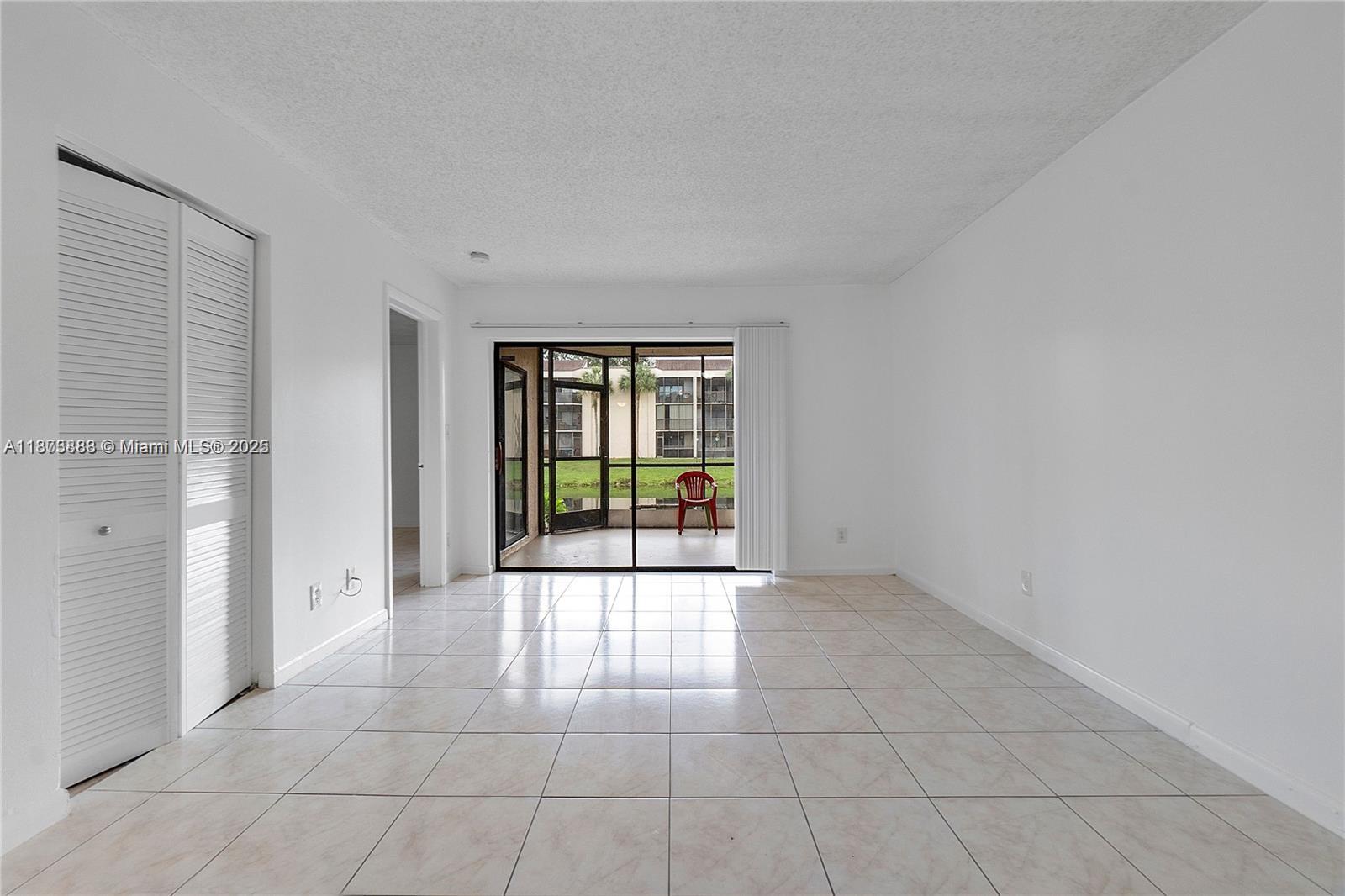 3399 Foxcroft Road, Unit 108 Miramar, FL 33025 - Photo 13 of 15 a view of an empty room with glass door