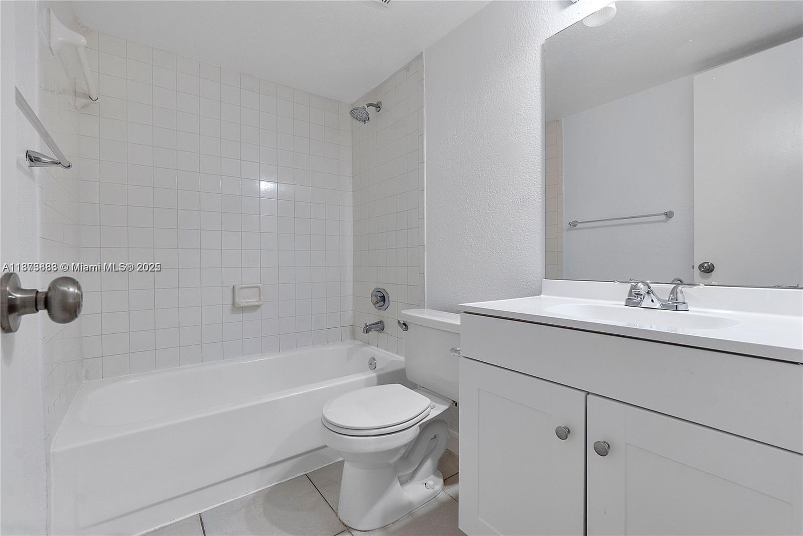 3399 Foxcroft Road, Unit 108 Miramar, FL 33025 - Photo 5 of 15 a bathroom with a sink a toilet and bathtub