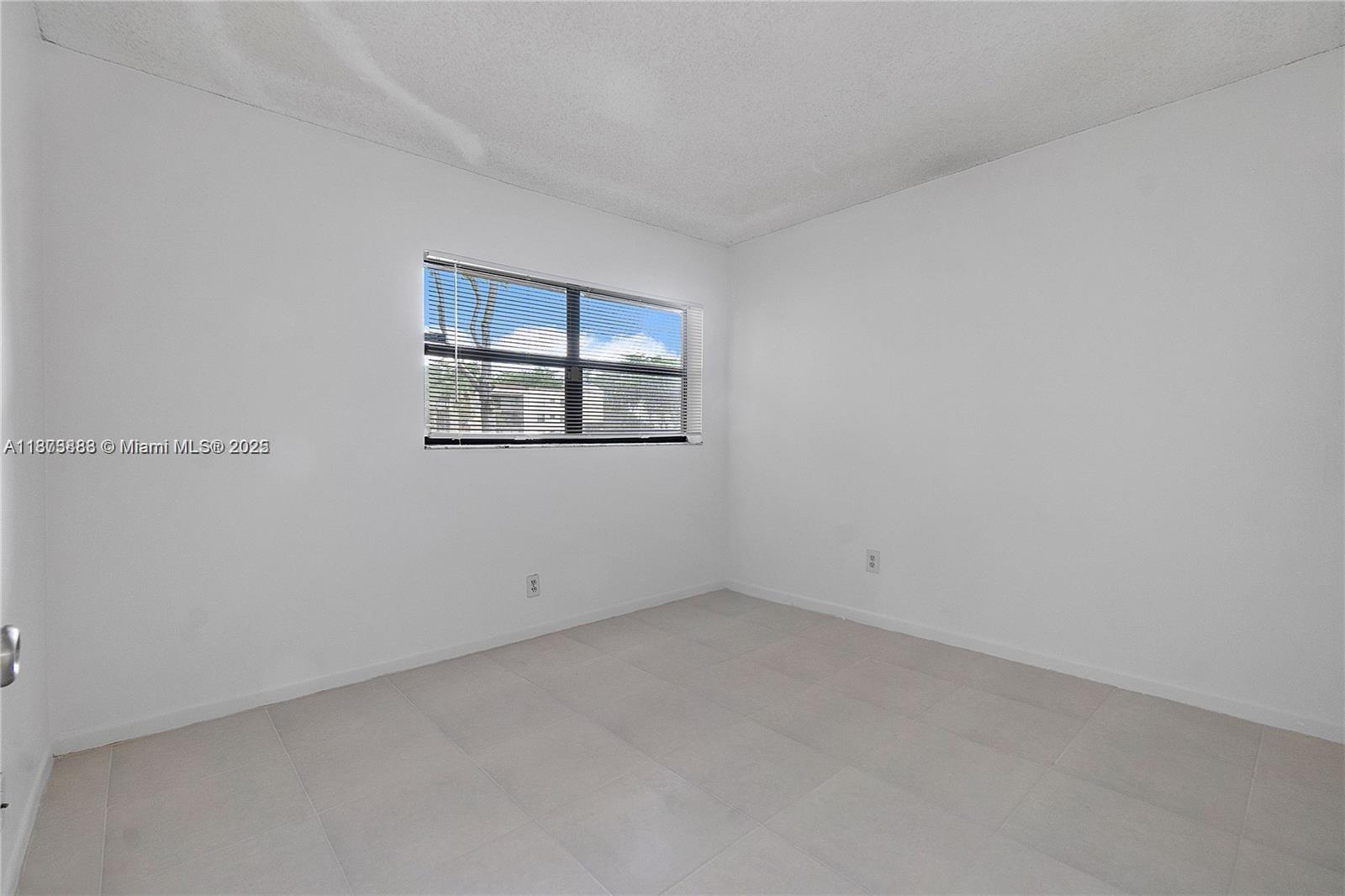 3399 Foxcroft Road, Unit 108 Miramar, FL 33025 - Photo 6 of 15 an empty room with windows