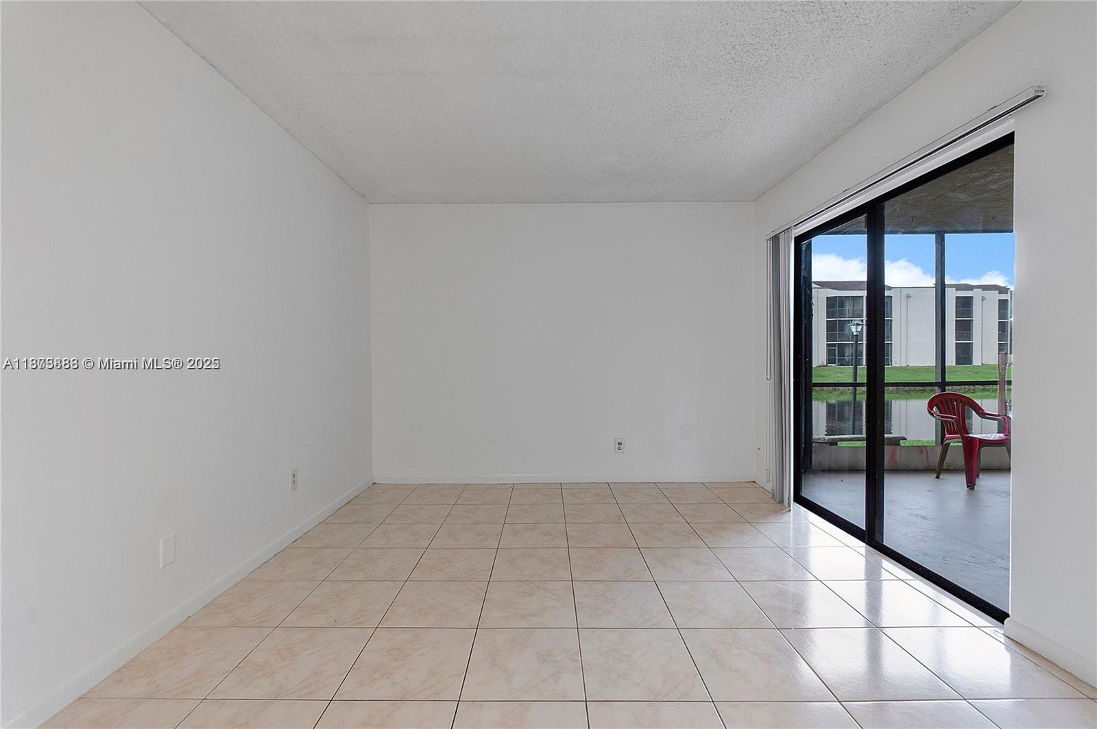 3399 Foxcroft Road, Unit 108 Miramar, FL 33025 - Photo 9 of 15 a view of an empty room and window