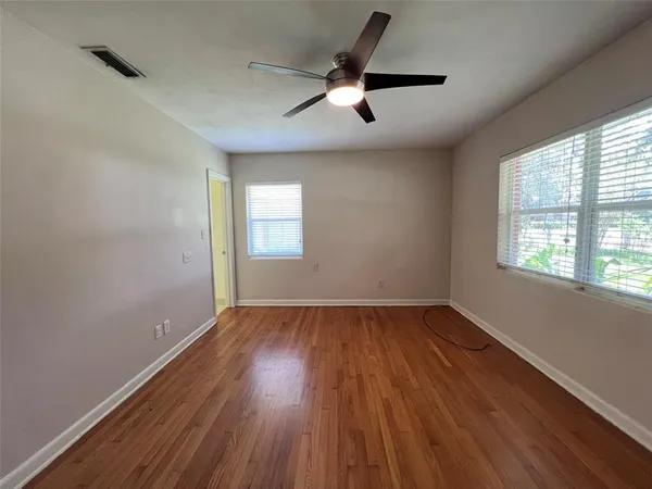 wooden floor in an empty room with a window