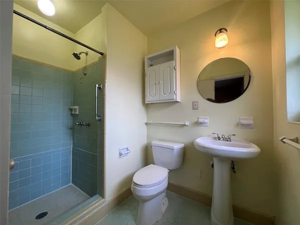 a bathroom with a toilet sink and shower