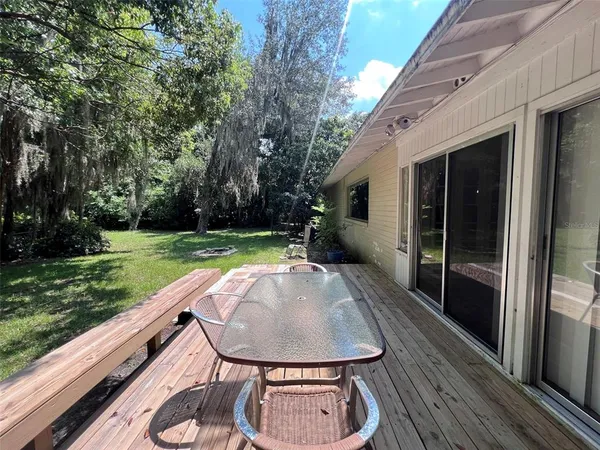a backyard of a house with outdoor seating