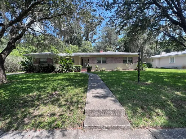 a view of house with a yard