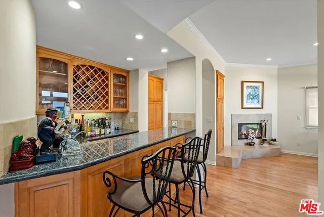 a kitchen with stainless steel appliances granite countertop a stove a sink and a wooden cabinets