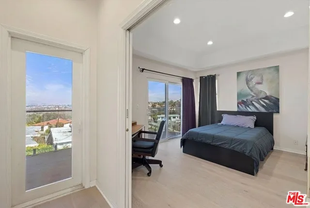 a bedroom with a bed and a desk