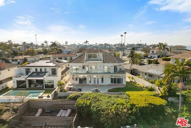 a view of a house with a big yard and large trees