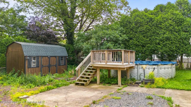 a view of a wooden deck in front of house with a yard
