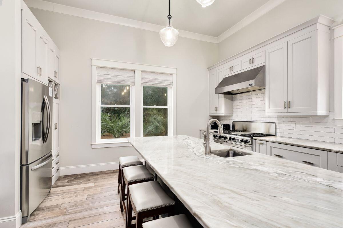 240 Overlook Drive Miramar Beach, FL 32550 - Photo 7 of 47 a kitchen with stainless steel appliances wooden floor and a refrigerator