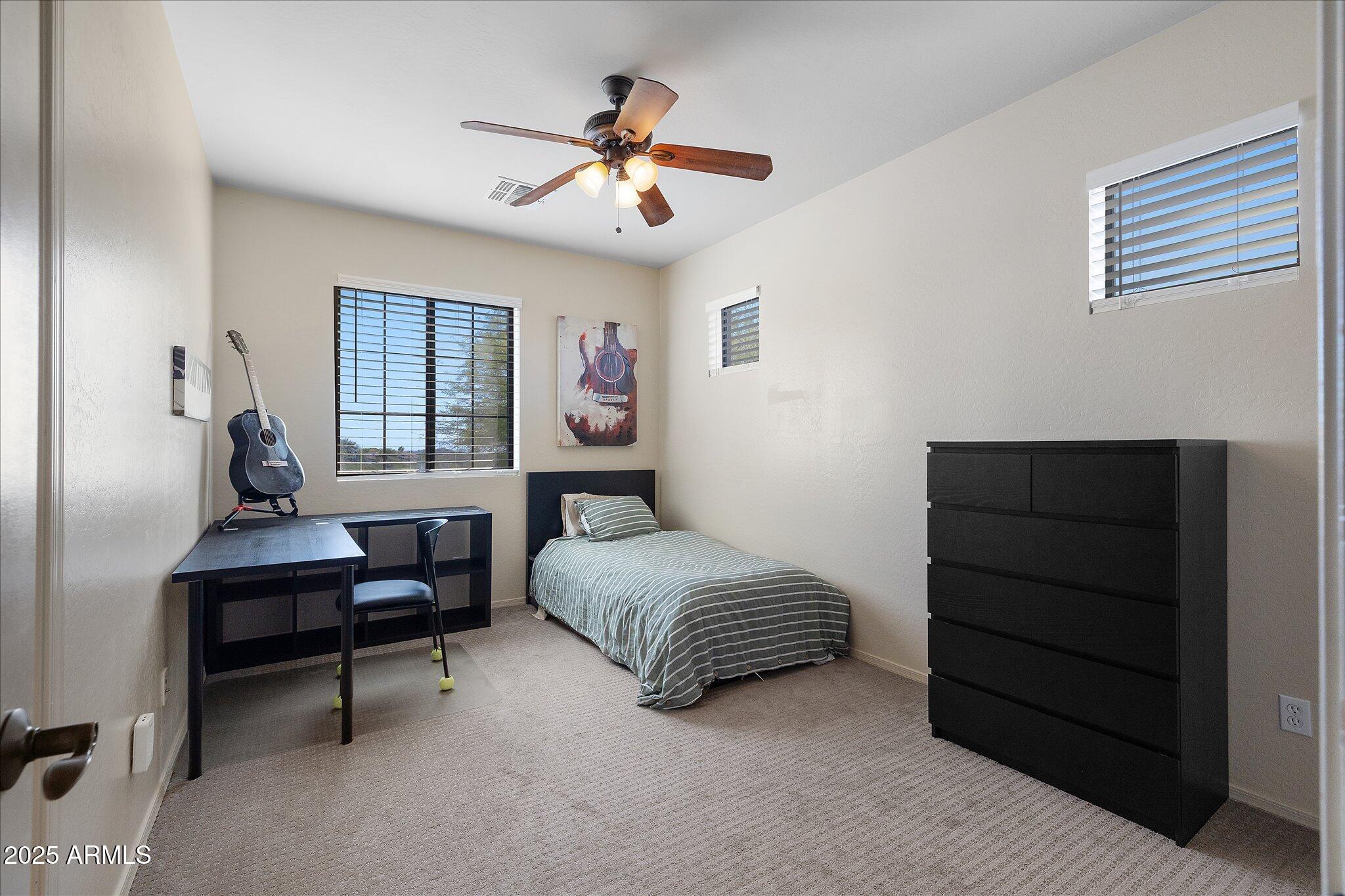 8536 East Inca Street Mesa, AZ 85207 - Photo 24 of 44 a spacious bedroom with a bed and a chandelier