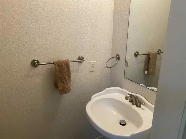 a bathroom with a sink and mirror