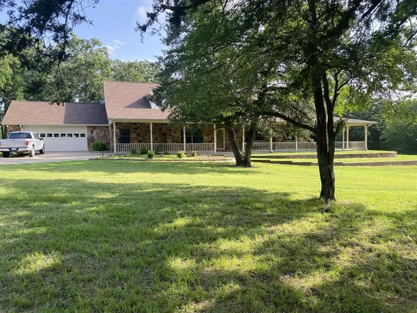 a view of a swimming pool with a patio and a yard