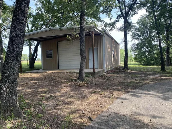 a backyard of a house with barbeque oven