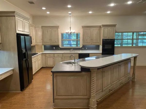 a kitchen with kitchen island a sink stainless steel appliances and window