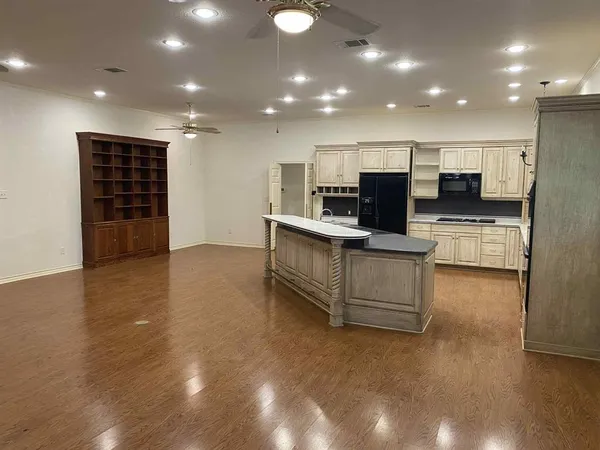 a view of kitchen with cabinets and wooden floor