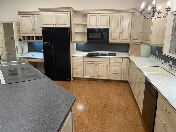 a kitchen with a sink stove and refrigerator