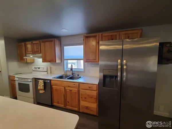 a kitchen with sink cabinets and wooden floor