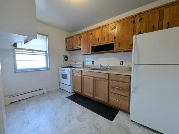 a kitchen with a white cabinets and white appliances