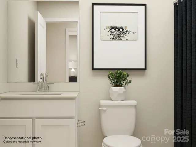 a bedroom with a bed a lamp and wooden floor