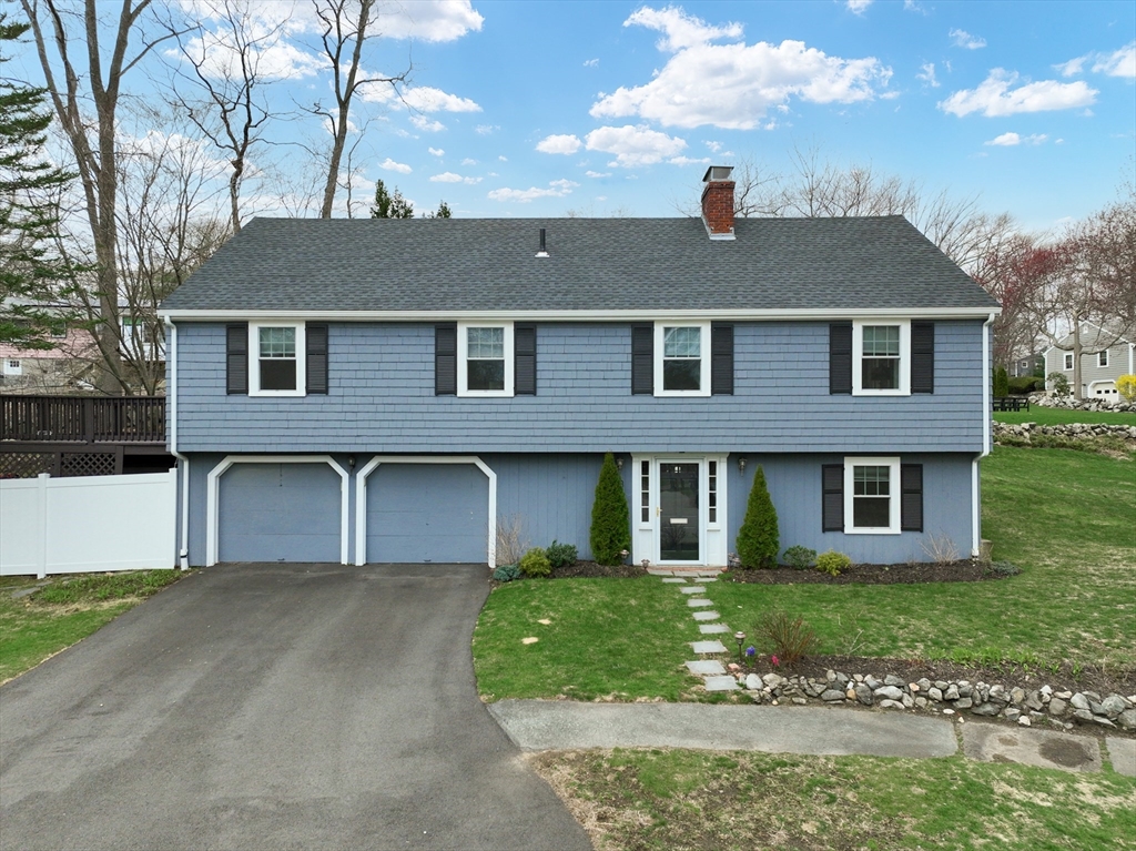23 Pine Ridge Circle Reading, MA 01867 - Photo 1 of 42 a front view of a house with a yard