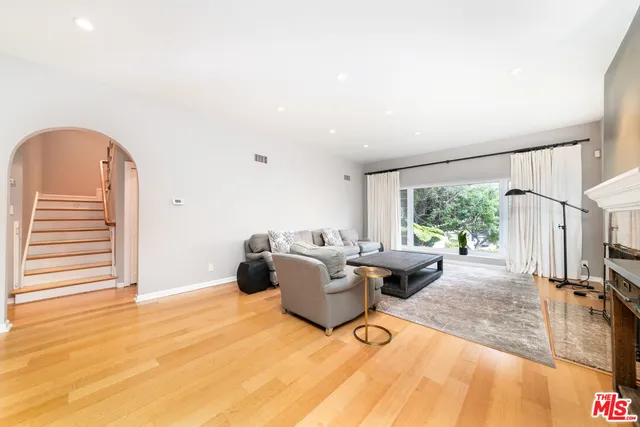 a living room with furniture a window and a table