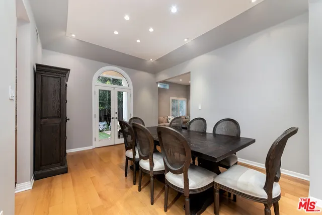 a dining room with furniture and wooden floor