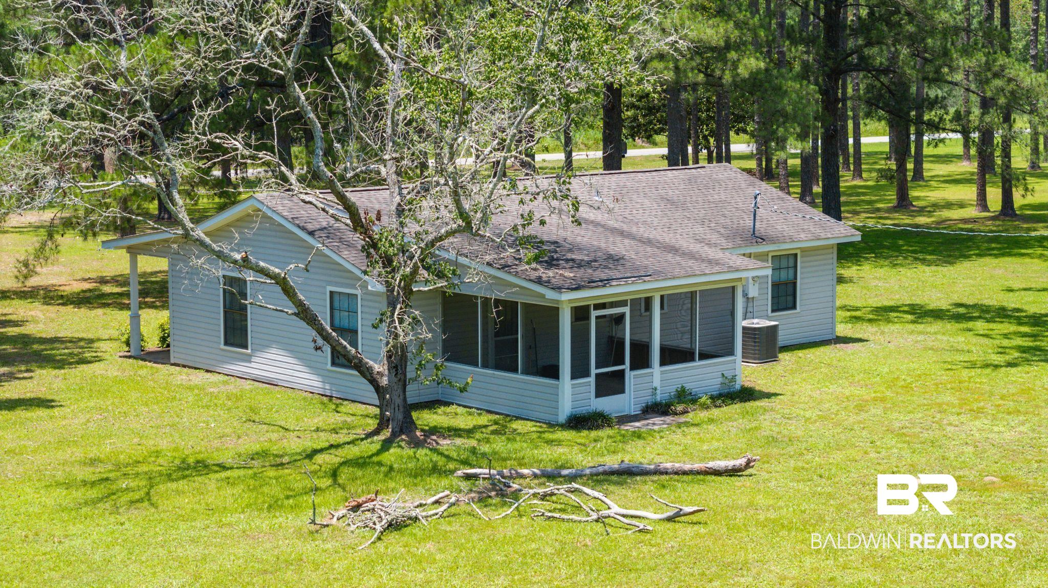 20540 Lacey Road Silverhill, AL 36576 - Photo 26 of 40 Light grey siding exterior with a dark shingle roof
