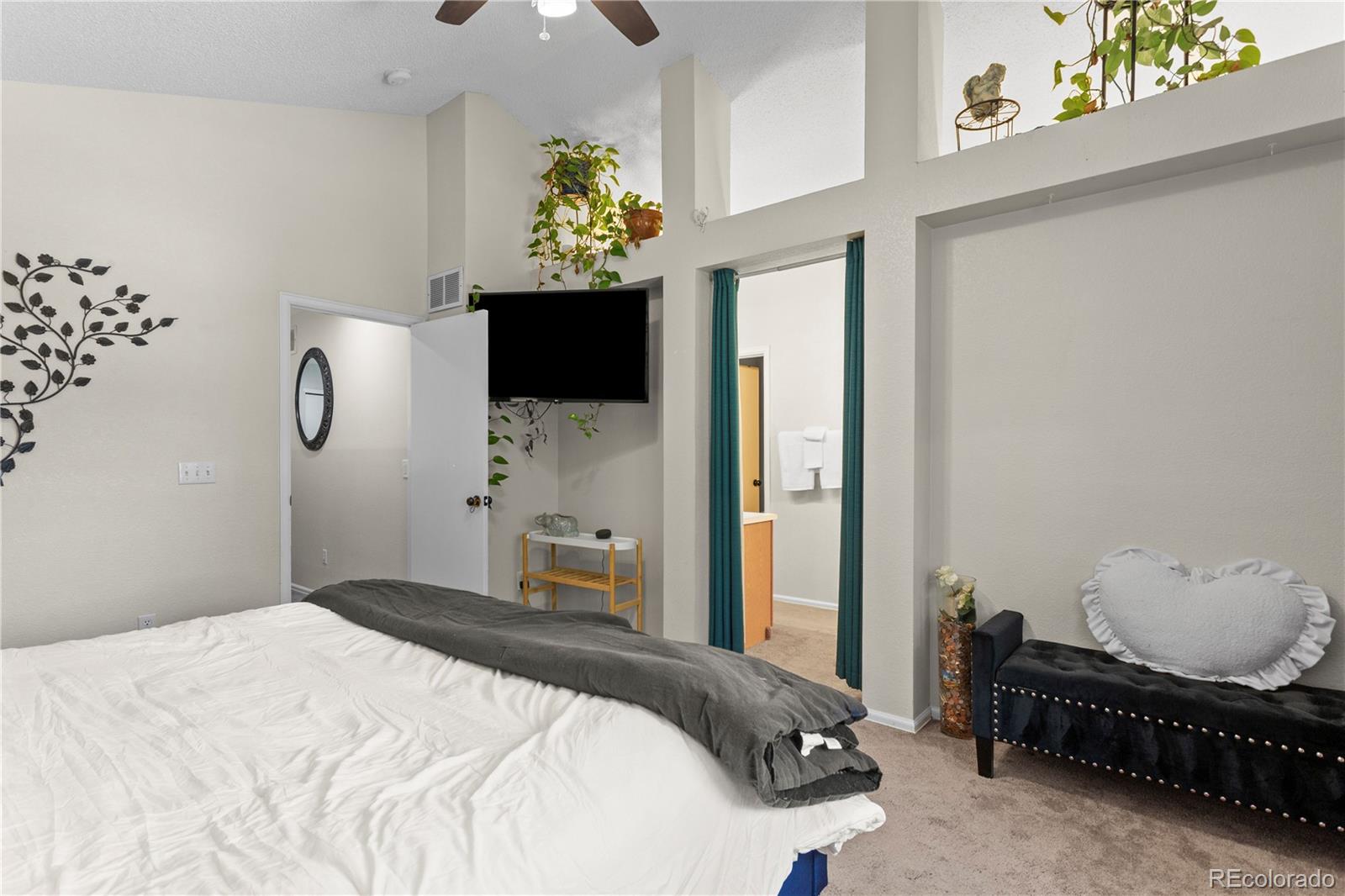2212 Hyacinth Road Littleton, CO 80129 - Photo 21 of 44 a bedroom with bed and mirror