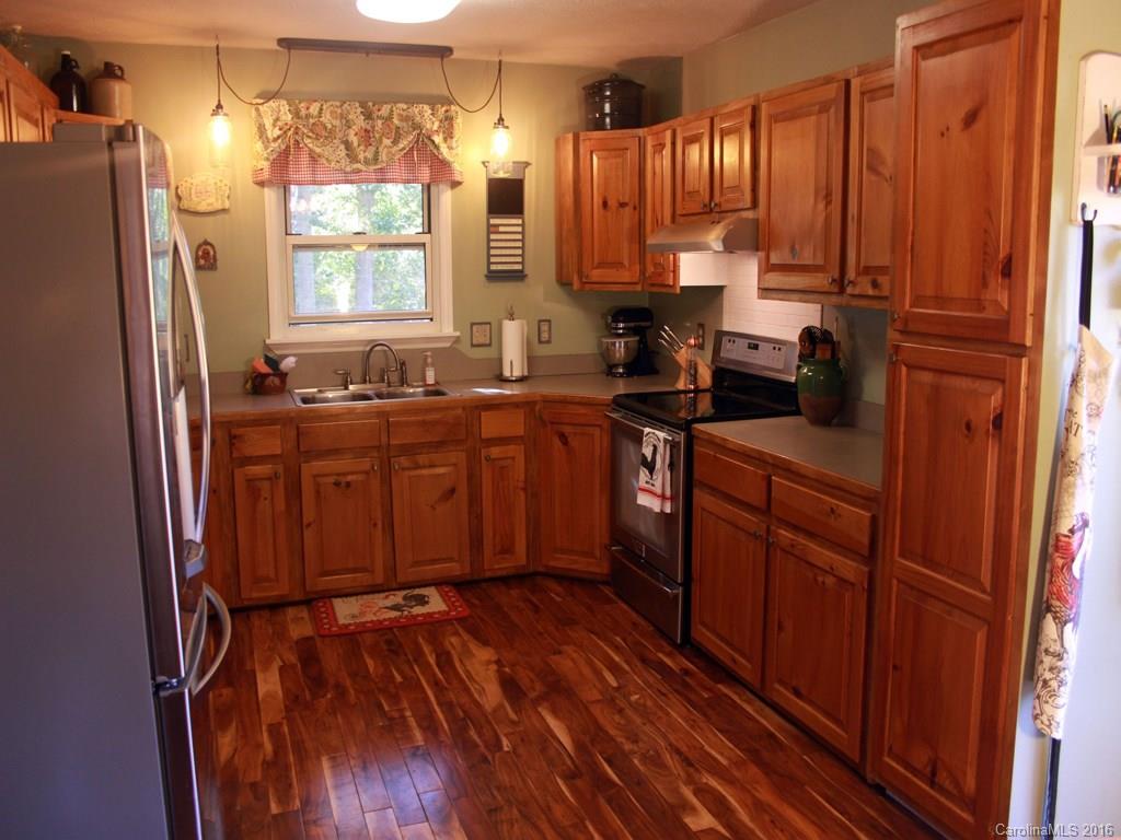 185 Loop Road Clyde, NC 28721 - Photo 2 of 24 a kitchen with stainless steel appliances a refrigerator sink and cabinets